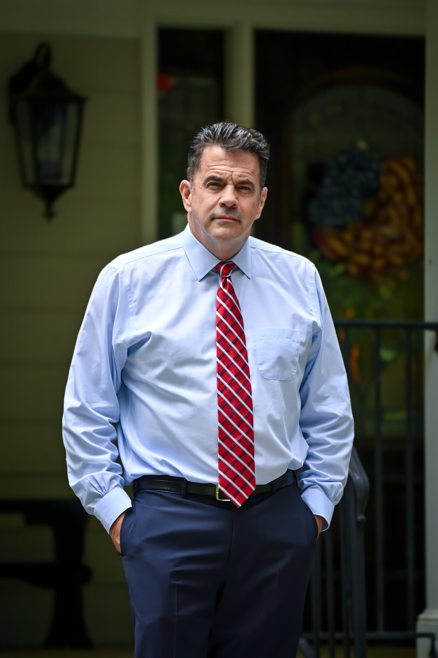 A man in a blue shirt and red tie